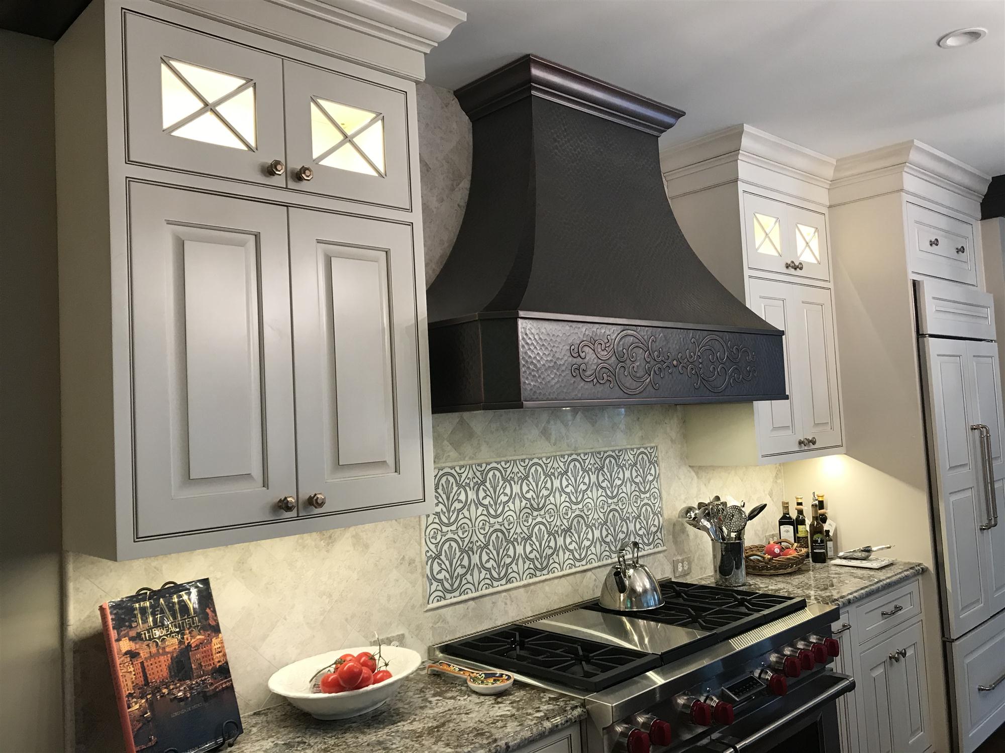 Traditional copper range hood with custom apron design