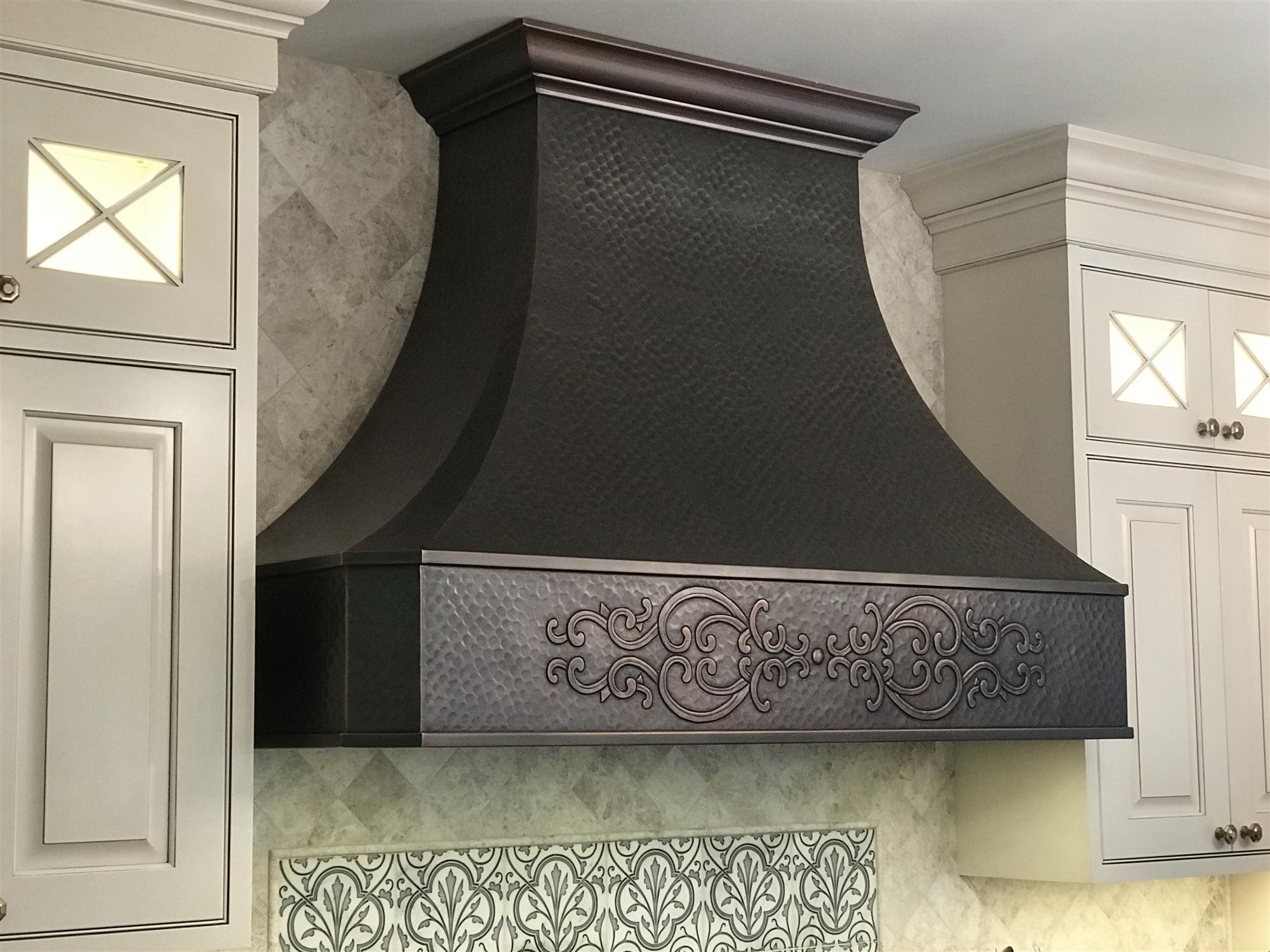 Traditional copper cooktop hood with custom design